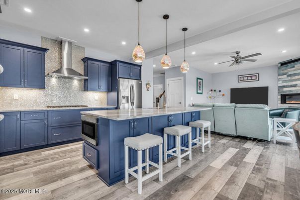 Fireplace, Interior, Kitchen, Living room, Pendant Lights, Recessed Lighting, Stainless Steel Appliances, Wood Texture Flooring
