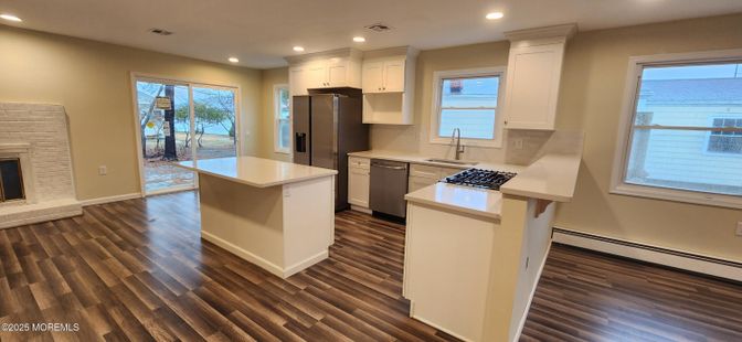 Fireplace, Interior, Kitchen, Recessed Lighting, Stainless Steel Appliances, Wood Texture Flooring