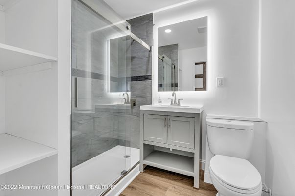 Bathroom, Glass Shower, Interior, Marble Walls, Recessed Lighting, Wood Texture Flooring