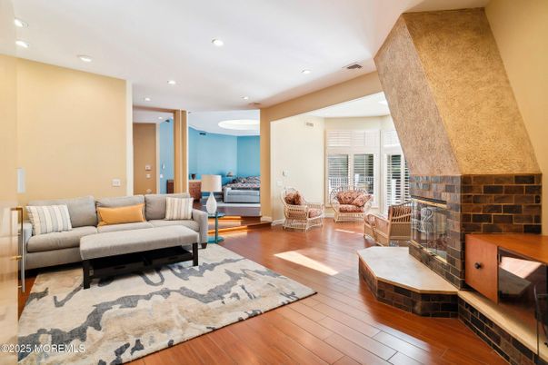 Fireplace, Interior, Living room, Recessed Lighting, Stone Walls, Wood Texture Flooring