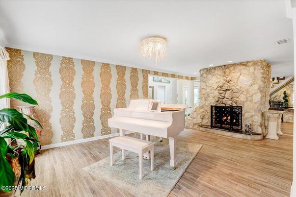 Chandelier, Fireplace, Interior, Piano, Recessed Lighting, Stone Walls, Wood Texture Flooring