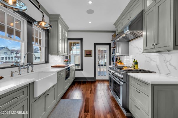 Interior, Kitchen, Marble Walls, Recessed Lighting, Stainless Steel Appliances, Wood Texture Flooring