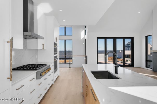 Interior, Kitchen, Marble Walls, Recessed Lighting, Stainless Steel Appliances, Wood Texture Flooring