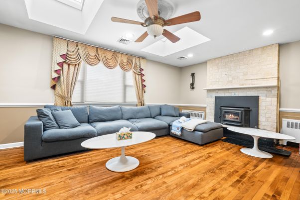 Fireplace, Interior, Living room, Recessed Lighting, Stone Walls, Wood Texture Flooring