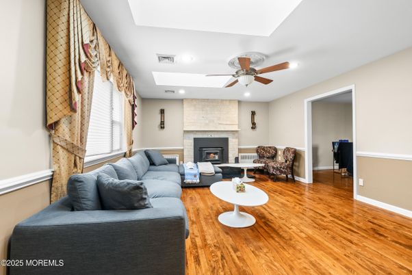 Fireplace, Interior, Living room, Recessed Lighting, Stone Walls, Wood Texture Flooring