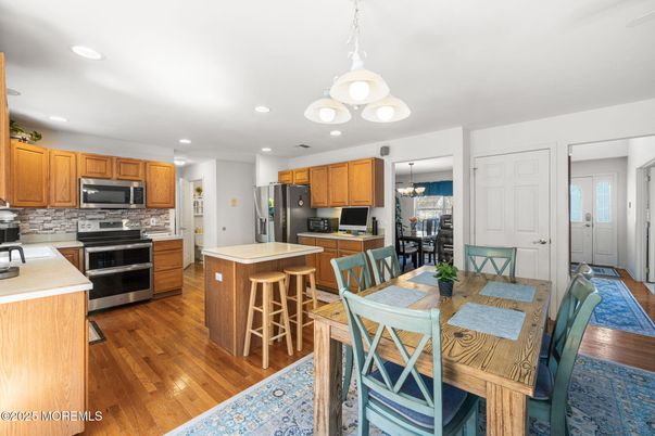 Chandelier, Dining room, Interior, Kitchen, Pendant Lights, Recessed Lighting, Stainless Steel Appliances, Wood Texture Flooring