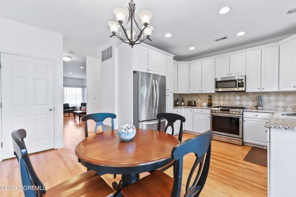 Chandelier, Dining room, Interior, Kitchen, Recessed Lighting, Stainless Steel Appliances, Wood Texture Flooring