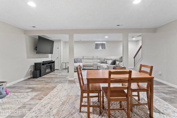 Dining room, Fireplace, Interior, Living room, Recessed Lighting, Wood Texture Flooring