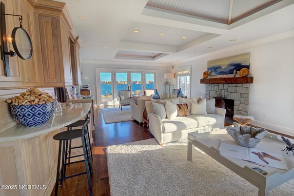 Fireplace, Interior, Living room, Recessed Lighting, Stone Walls, Water, Wood Texture Flooring