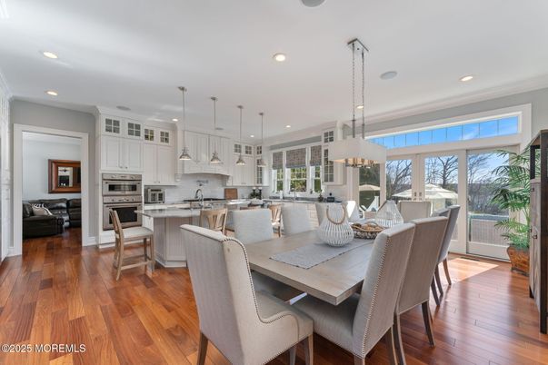 Chandelier, Dining room, Interior, Kitchen, Living room, Pendant Lights, Recessed Lighting, Stainless Steel Appliances, Wood Texture Flooring