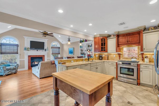 Fireplace, Interior, Kitchen, Living room, Pendant Lights, Recessed Lighting, Stainless Steel Appliances, Wood Texture Flooring