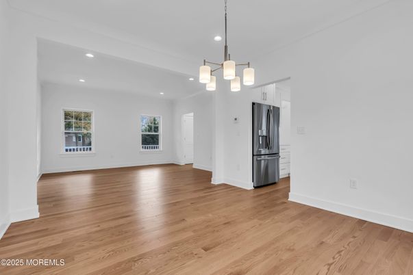 Chandelier, Empty room, Interior, Kitchen, Pendant Lights, Recessed Lighting, Stainless Steel Appliances, Wood Texture Flooring