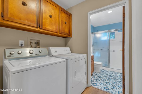 Bathroom, Glass Shower, Interior, Recessed Lighting, Utility Closets, Washer, Wood Texture Flooring