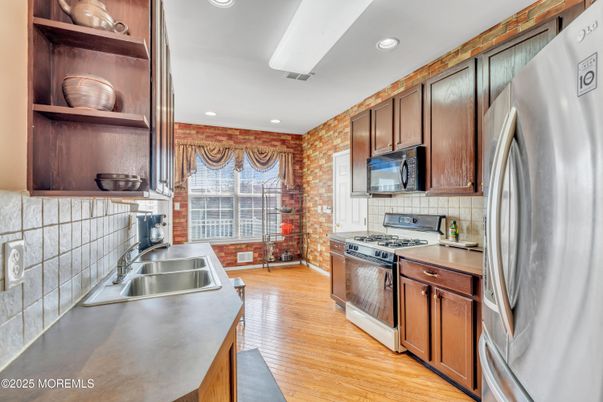 Interior, Kitchen, Recessed Lighting, Stainless Steel Appliances, Stone Walls, Wood Texture Flooring