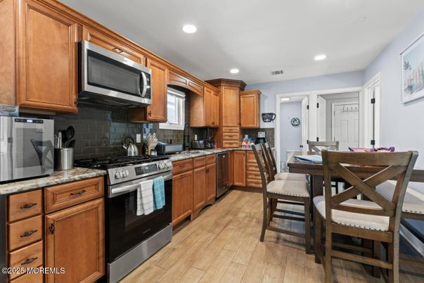 Dining room, Interior, Kitchen, Recessed Lighting, Stainless Steel Appliances, Wood Texture Flooring