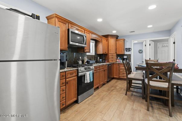 Dining room, Interior, Kitchen, Recessed Lighting, Stainless Steel Appliances, Wood Texture Flooring