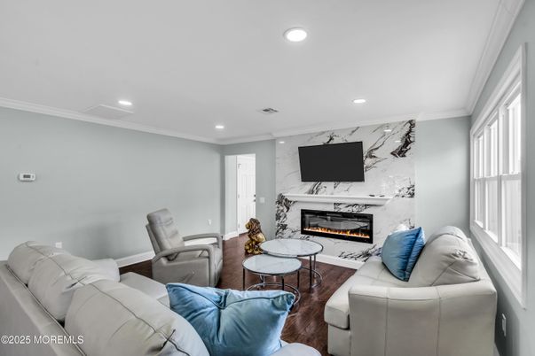 Fireplace, Interior, Living room, Marble Walls, Recessed Lighting, Wood Texture Flooring