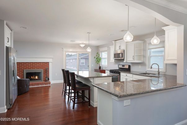 Fireplace, Interior, Kitchen, Pendant Lights, Recessed Lighting, Stainless Steel Appliances, Wood Texture Flooring