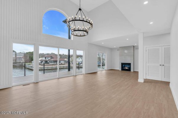Chandelier, Empty room, Fireplace, Interior, Pendant Lights, Recessed Lighting, Wood Texture Flooring