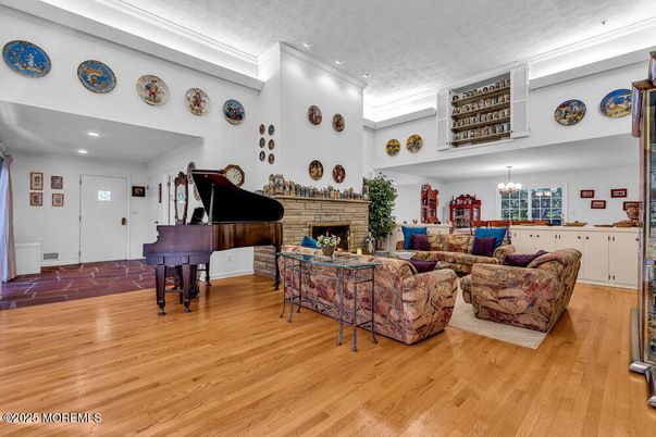Chandelier, Fireplace, Interior, Living room, Piano, Recessed Lighting, Wood Texture Flooring