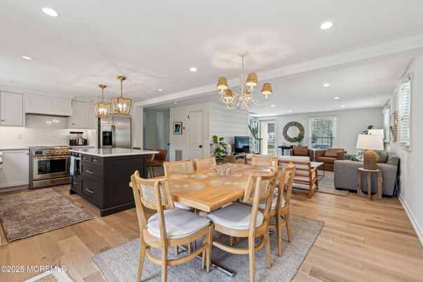 Chandelier, Dining room, Interior, Kitchen, Living room, Pendant Lights, Recessed Lighting, Stainless Steel Appliances, Wood Texture Flooring