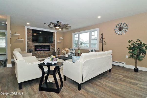 Fireplace, Interior, Living room, Recessed Lighting, Stone Walls, Wood Texture Flooring