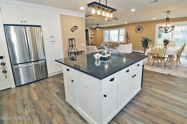 Chandelier, Dining room, Interior, Kitchen, Pendant Lights, Recessed Lighting, Stainless Steel Appliances, Wood Texture Flooring