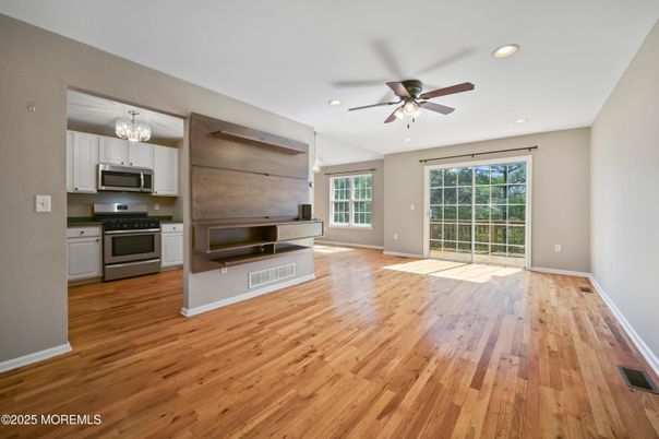 Chandelier, Empty room, Interior, Kitchen, Recessed Lighting, Stainless Steel Appliances, Wood Texture Flooring