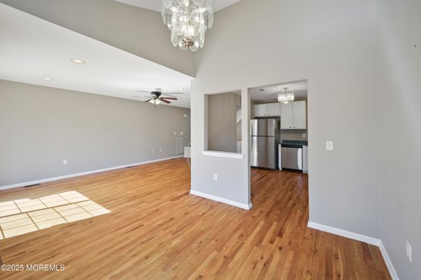 Chandelier, Empty room, Interior, Kitchen, Recessed Lighting, Stainless Steel Appliances, Wood Texture Flooring