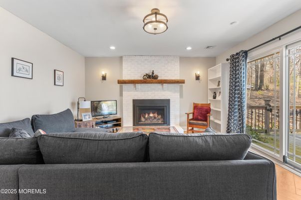 Fireplace, Interior, Living room, Recessed Lighting, Stone Walls, Wood Texture Flooring