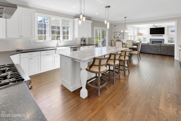 Chandelier, Dining room, Fireplace, Interior, Kitchen, Living room, Pendant Lights, Recessed Lighting, Stainless Steel Appliances, Wood Texture Flooring