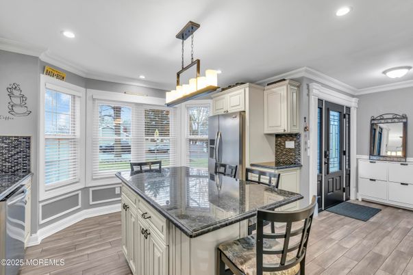 Chandelier, Dining room, Interior, Kitchen, Pendant Lights, Recessed Lighting, Stainless Steel Appliances, Wood Texture Flooring