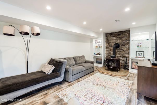 Fireplace, Interior, Living room, Recessed Lighting, Stone Walls, Wood Texture Flooring
