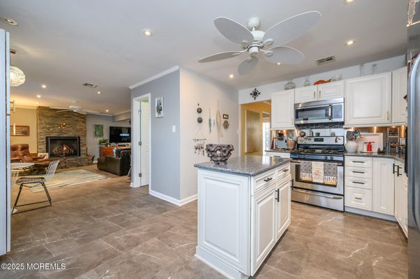 Fireplace, Interior, Kitchen, Recessed Lighting, Stainless Steel Appliances, Stone Walls