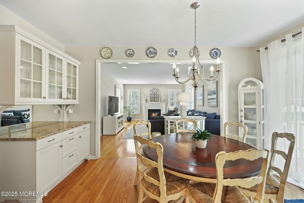 Chandelier, Dining room, Fireplace, Interior, Living room, Pendant Lights, Recessed Lighting, Wood Texture Flooring
