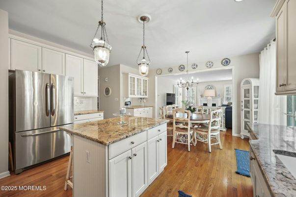 Chandelier, Dining room, Interior, Kitchen, Pendant Lights, Recessed Lighting, Stainless Steel Appliances, Wood Texture Flooring