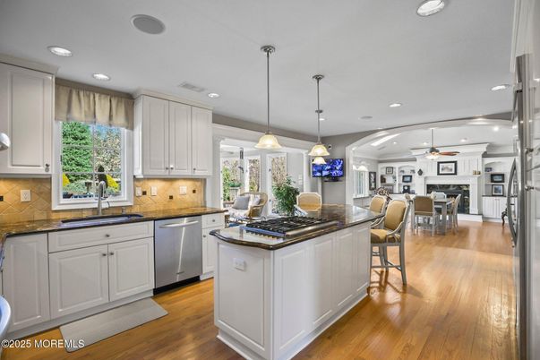 Dining room, Fireplace, Interior, Kitchen, Pendant Lights, Recessed Lighting, Stainless Steel Appliances, Wood Texture Flooring