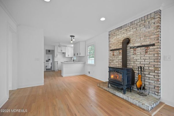 Fireplace, Interior, Kitchen, Recessed Lighting, Stone Walls, Wood Texture Flooring