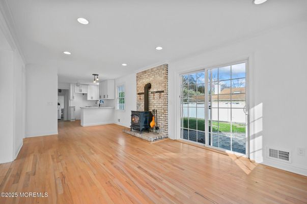Empty room, Fireplace, Interior, Kitchen, Recessed Lighting, Stone Walls, Wood Texture Flooring