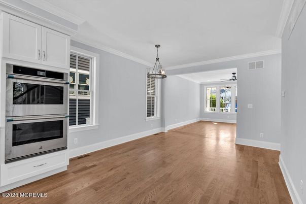 Empty room, Interior, Kitchen, Pendant Lights, Stainless Steel Appliances, Wood Texture Flooring