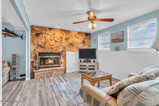 Fireplace, Interior, Living room, Recessed Lighting, Stone Walls, Wood Texture Flooring