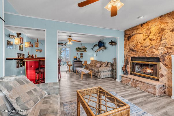 Fireplace, Interior, Living room, Recessed Lighting, Stone Walls, Wood Texture Flooring