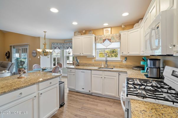 Chandelier, Dining room, Interior, Kitchen, Recessed Lighting, Stainless Steel Appliances, Wood Texture Flooring