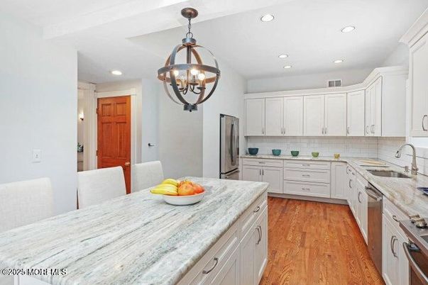 Chandelier, Dining room, Interior, Kitchen, Pendant Lights, Recessed Lighting, Stainless Steel Appliances, Wood Texture Flooring