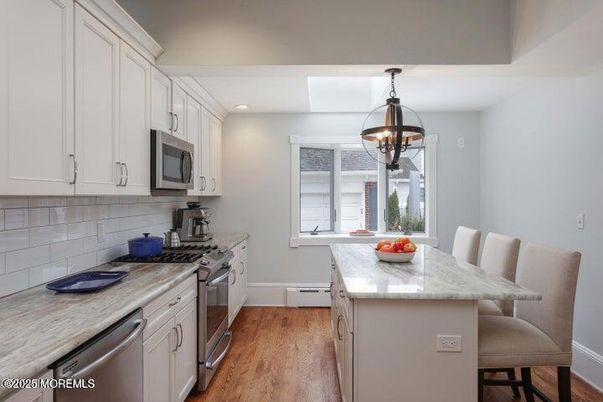 Chandelier, Dining room, Interior, Kitchen, Recessed Lighting, Stainless Steel Appliances, Wood Texture Flooring