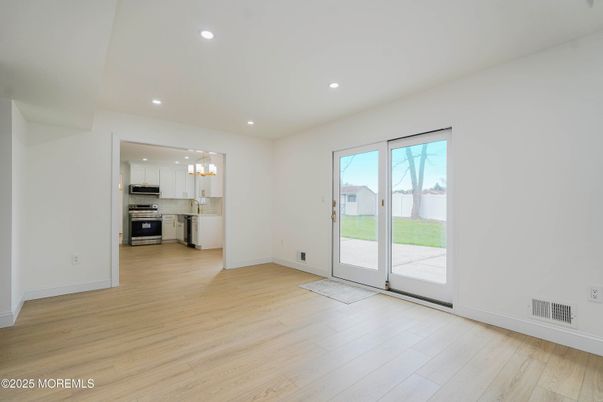Empty room, Interior, Kitchen, Pendant Lights, Recessed Lighting, Stainless Steel Appliances, Wood Texture Flooring