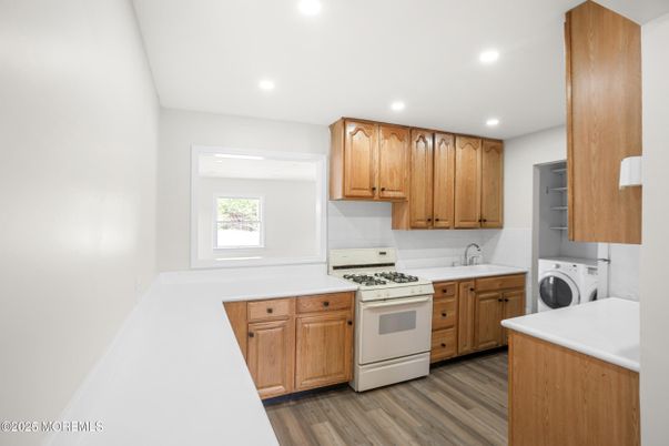 Interior, Kitchen, Recessed Lighting, Washer, Wood Texture Flooring