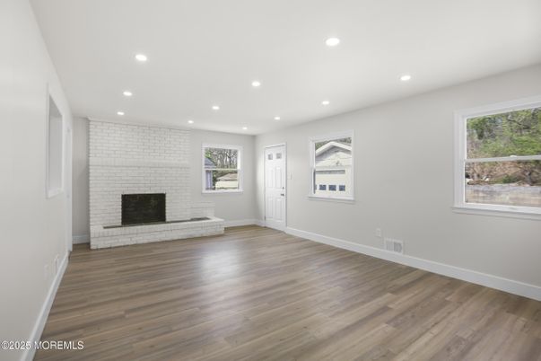 Empty room, Fireplace, Interior, Recessed Lighting, Stone Walls, Wood Texture Flooring