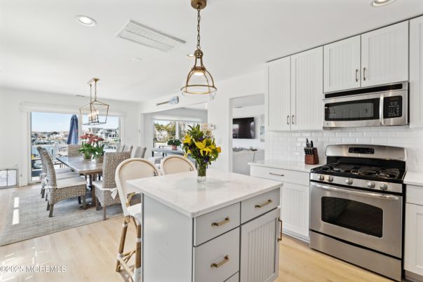 Dining room, Interior, Kitchen, Pendant Lights, Recessed Lighting, Stainless Steel Appliances, Wood Texture Flooring