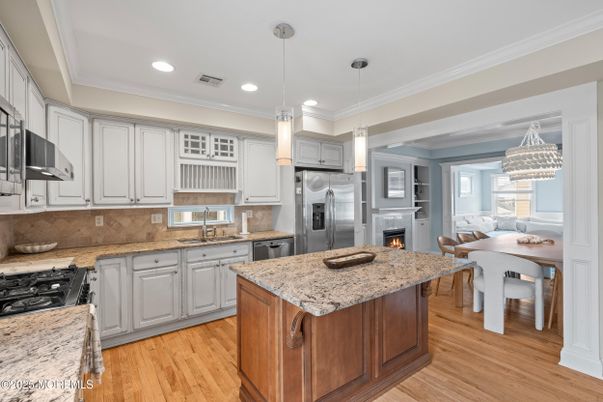 Dining room, Fireplace, Interior, Kitchen, Pendant Lights, Recessed Lighting, Stainless Steel Appliances, Wood Texture Flooring